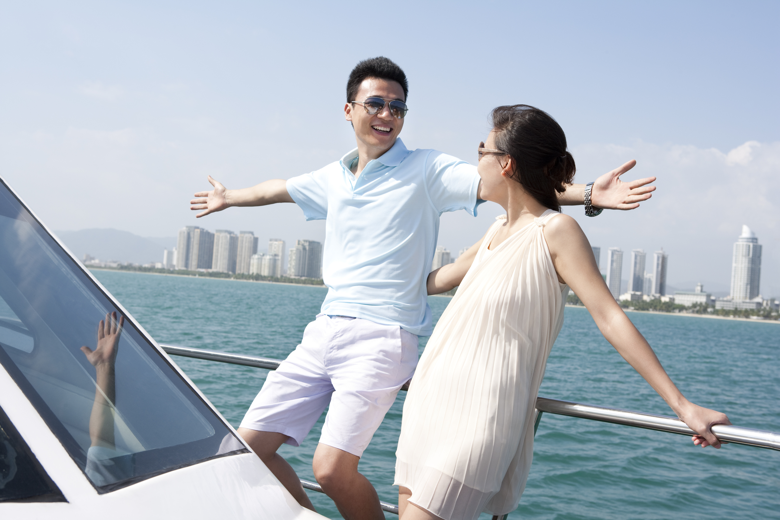 Cheerful young couple posing on Dubai Yachts
