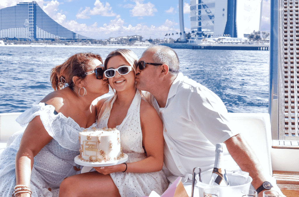 A family celebrating yacht birthday party on luxury Dubai Yachts